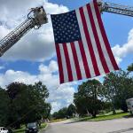 Members of the Egypt Fire Department hung an American flag at the entrance of White Haven Memorial Park in Pittsford, where P.O. Mazurkiewicz rests in peace. The "Ride for Maz" motorcade visited the park during the ride from Henrietta to Fairport.